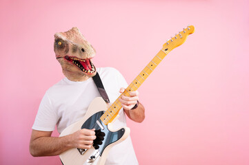 Man with lizard mask playing electric guitar