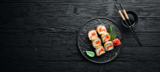 Sushi rolls with tuna and caviar. Sushi set on a black stone plate. Top view.