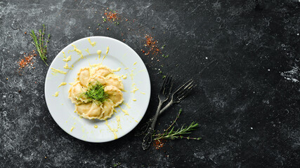 Potato dumplings with sour cream. Ukrainian cuisine. Top view, free space for your text. Rustic style.