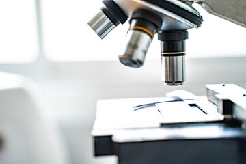 close up microscope stage and objectives researching corona virus microscopic cells behavior testing vaccination cure, in medical center lab china Wuhan world health organization research facilities