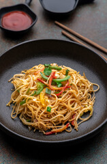 stir fried vegetarian noodles with sauce and chopsticks