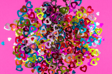 Pink background with colorful hearts. Love concept, Valentine's Day greeting card. View from above. The basis for the postcard.
