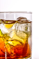 god mother alcoholic cocktail, close up of the glass with transparent ice cubes