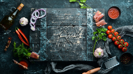 Black banner. Background of cooking, spices and vegetables. Top view. Free space for your text.