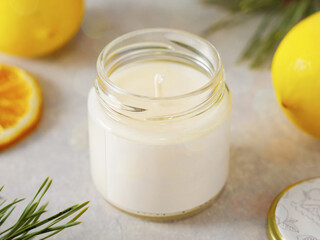 Obraz na płótnie Canvas Aroma candle with scent of citrus. New Year's atmosphere. Aromatherapy photo with citrus fruits. horizontal orientation. candle with the aroma of lemon, citrus. New Year's mood. Aromatherapy.