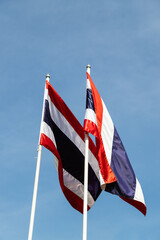 Image of waving flag of Thailand with blue sky background.