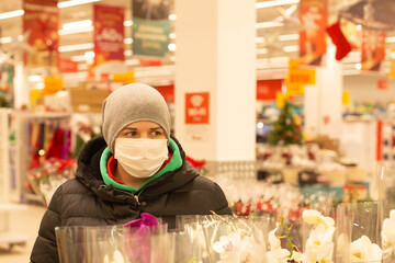 Girl in a protective mask in a supermarket