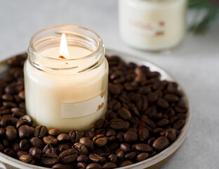 Burning aromatic coffee candle and coffee beans, close-up. Aromatherapy. Coffee atmosphere. The aroma of coffee.