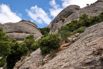 View of the rocks. Mountains with green vegetation. Steep descent from the mountain.