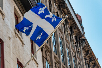 Fototapeta premium Quebec flag flying in Old Montreal, Canada