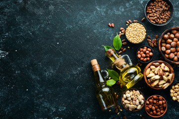 Cold pressed nut oil. Assortment of nuts. free space for your text. Top view.