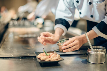 Hand of man take cooking of meat with vegetable grill, Chef cooking wagyu beef in Japanese teppanyaki restaurant