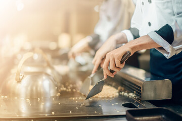 Hand of man take cooking of meat with vegetable grill, Chef cooking wagyu beef in Japanese teppanyaki restaurant