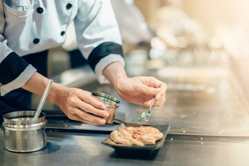 Hand of man take cooking of meat with vegetable grill, Chef cooking wagyu beef in Japanese teppanyaki restaurant