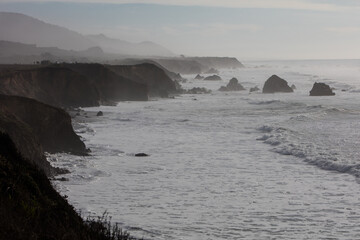 Obraz premium The cold waters of the Pacific Ocean beat against the rocky coastline of Northern California in Mendocino. The scenic Pacific Coast Highway runs along this amazing part of the west coast.