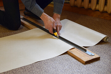 Cutting the wallpaper.