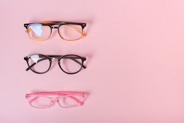 several different glasses on a pink background