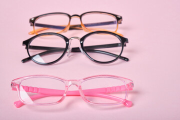 several different glasses on a pink background