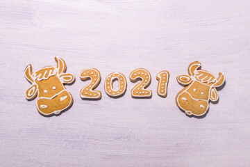 Happy New Year's set of numbers 2021, gingerbread santa claus and symbol of year from ginger biscuits glazed sugar icing decoration on light background.