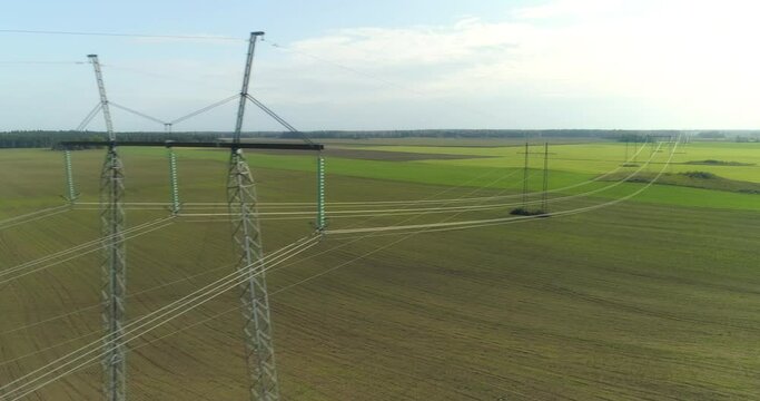 Electricity high voltage power lines and towers aerial view drone shot