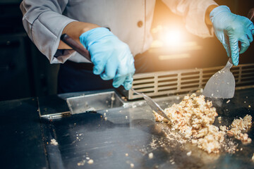 Hand of man take cooking of meat with vegetable grill, Chef cooking wagyu beef in Japanese teppanyaki restaurant