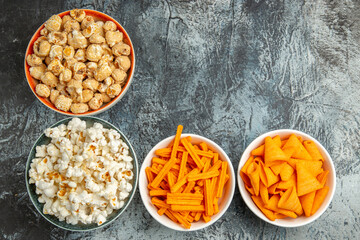 top view different snacks popcorn rusks and cips on light background snack movie cinema