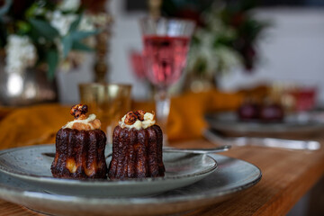 two muffins c with cream on gray ceramic plates on festive table