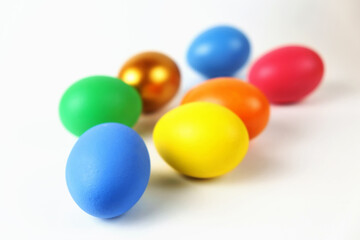 Bunch of colorful Easter eggs on the white surface, selective focus