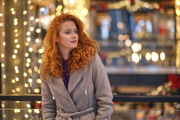 Close-up of smiling girl surrounded with lights. christmas time