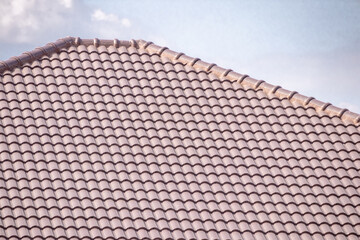 Ceramic roof tiles on the house with blue sky