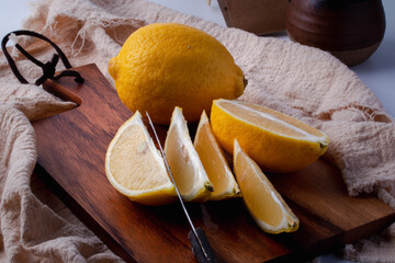 Yellow lemon on a wooden cutting board