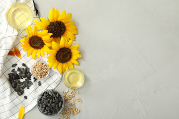 Flat lay composition with sunflower oil on grey table, space for text