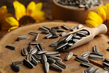Raw sunflower seeds on wooden stand, closeup
