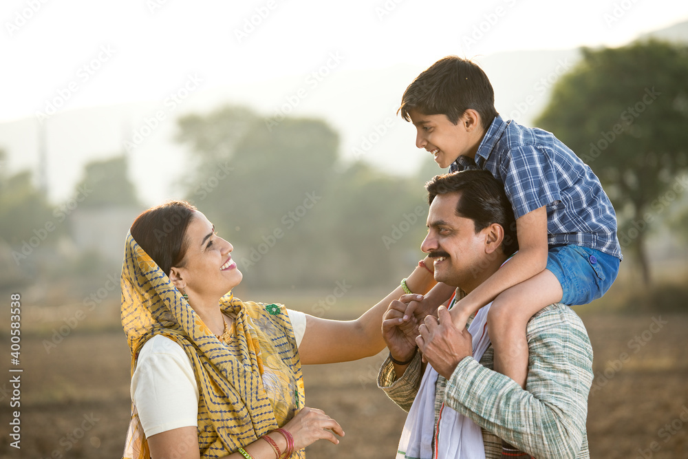 Wall mural happy rural indian family on agricultural field