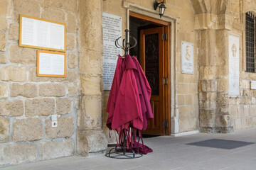 Fototapeta na wymiar Red robes for women at the main gate of Orthodox Church of Saint Lazarus in Larnaca (Larnaka) Cyprus