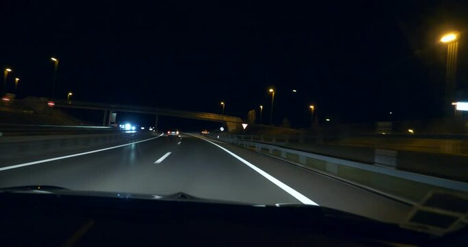 Driving Car at Night on Highway. POV Windshield Hood View