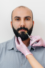 Cosmetic procedure for lip augmentation and wrinkle removal for a bearded man. Cosmetology