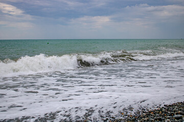 The Black Sea coast of Sochi on a warm, cloudy summer day.