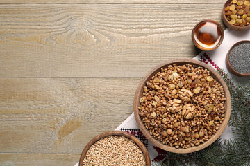 Flat lay composition with tasty traditional kutia on wooden table, space for text