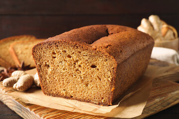 Delicious gingerbread cake on wooden board, closeup