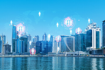 Skyscrapers of Dubai business downtown. International hub of trading and financial services. Social network icons hologram, concept of people connection. Double exposure. Dubai Canal waterfront.