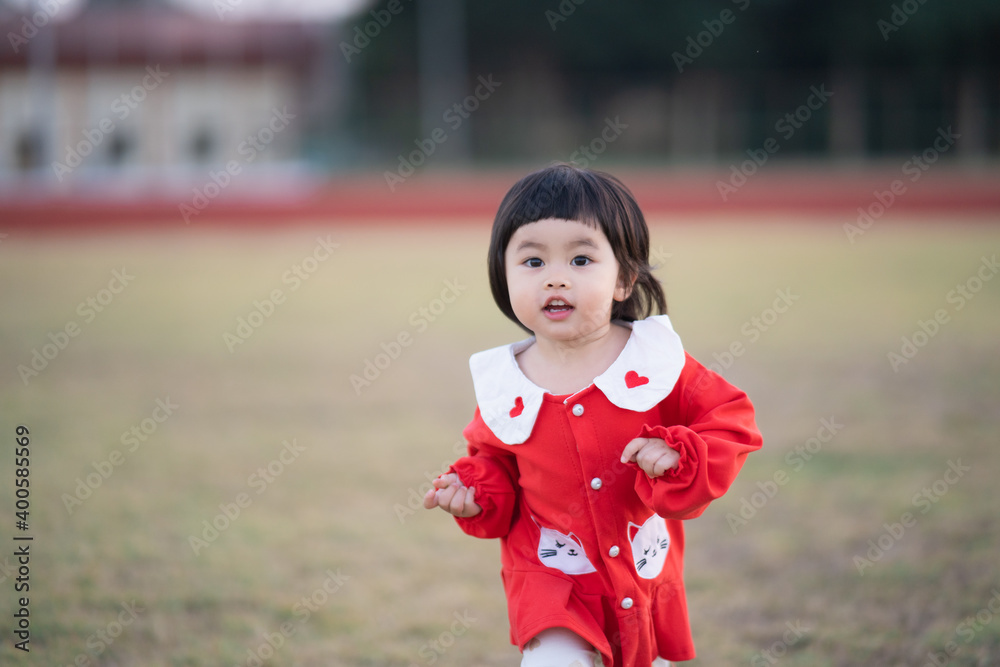 Wall mural cute baby running at the stadium