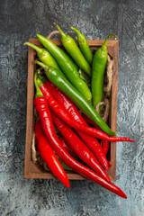 top view colored spicy peppers on dark-light background pepper ripe photo