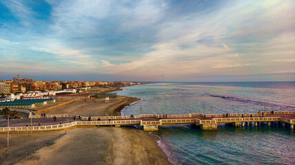 Sunset Rome aerial view in Ostia Lido beach over blue sea and brown sandy beach, beautiful coast...