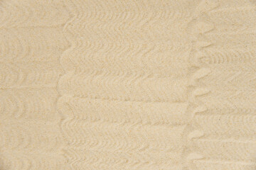 Zen sand garden meditation stone background with copy space. Stones and lines drawing in sand for relaxation. Concept of harmony, balance and meditation, spa, massage, relax. Set Sail Champagne color