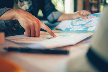 Close-up Tourist planning vacation with map and other travel accessories on the table. Travel,...