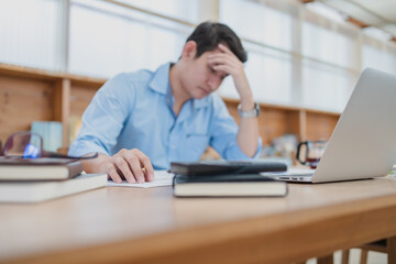 Naklejka premium Tired businessman hold pencil at workplace in office and headache or angry. Overworking, making mistake, stress, termination, fail, bad, sad tired or depression concept