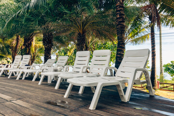 Obraz premium Lounge chairs near the pool at the hotel.