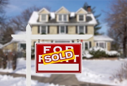 Sold Home For Sale Real Estate Sign In Front Of New Snow Covered House