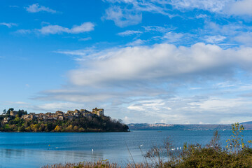 Italian city of Anguillara, located on a cliff next to a lake